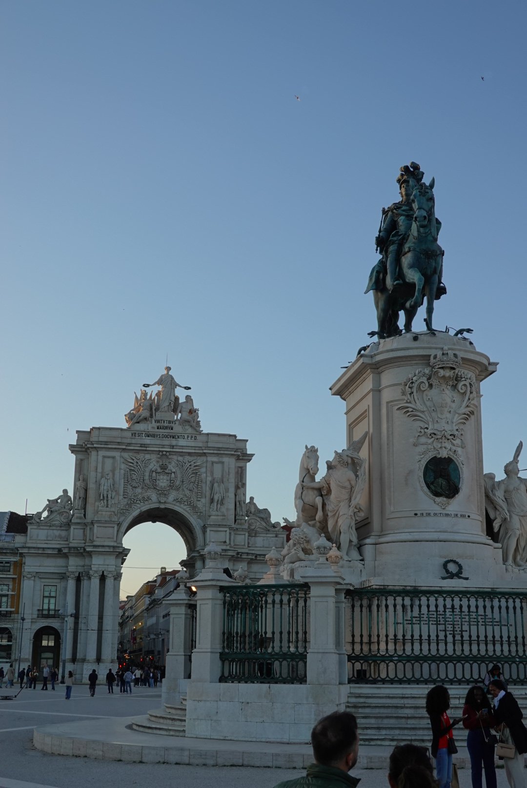 Equestrian statue of King José I and the Arco da Rua Augusta at Praça do Comércio under a blue dusk sky